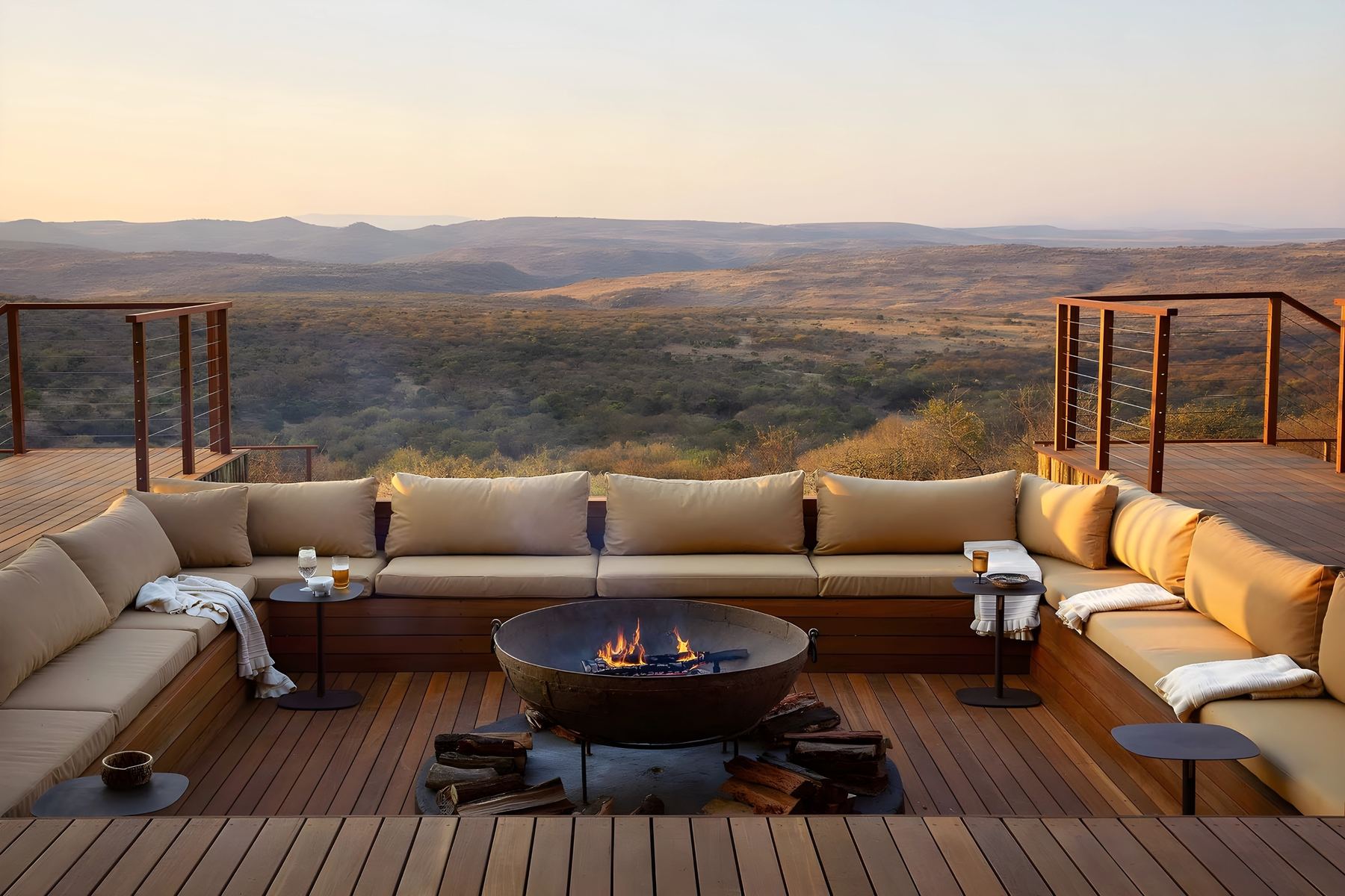 The sunken fire pit on the deck, with the hills turning gold at sunset