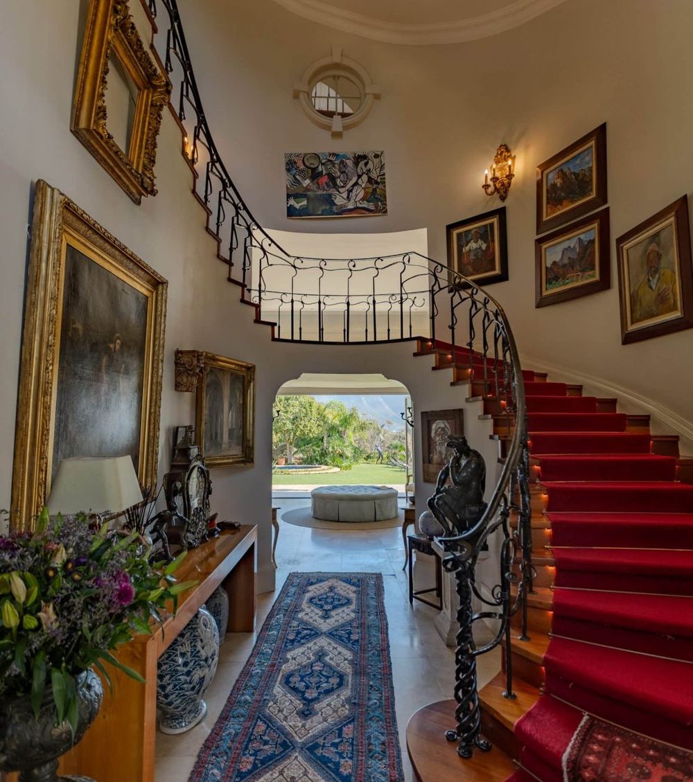 The staircase hall, hung with the owners' collection