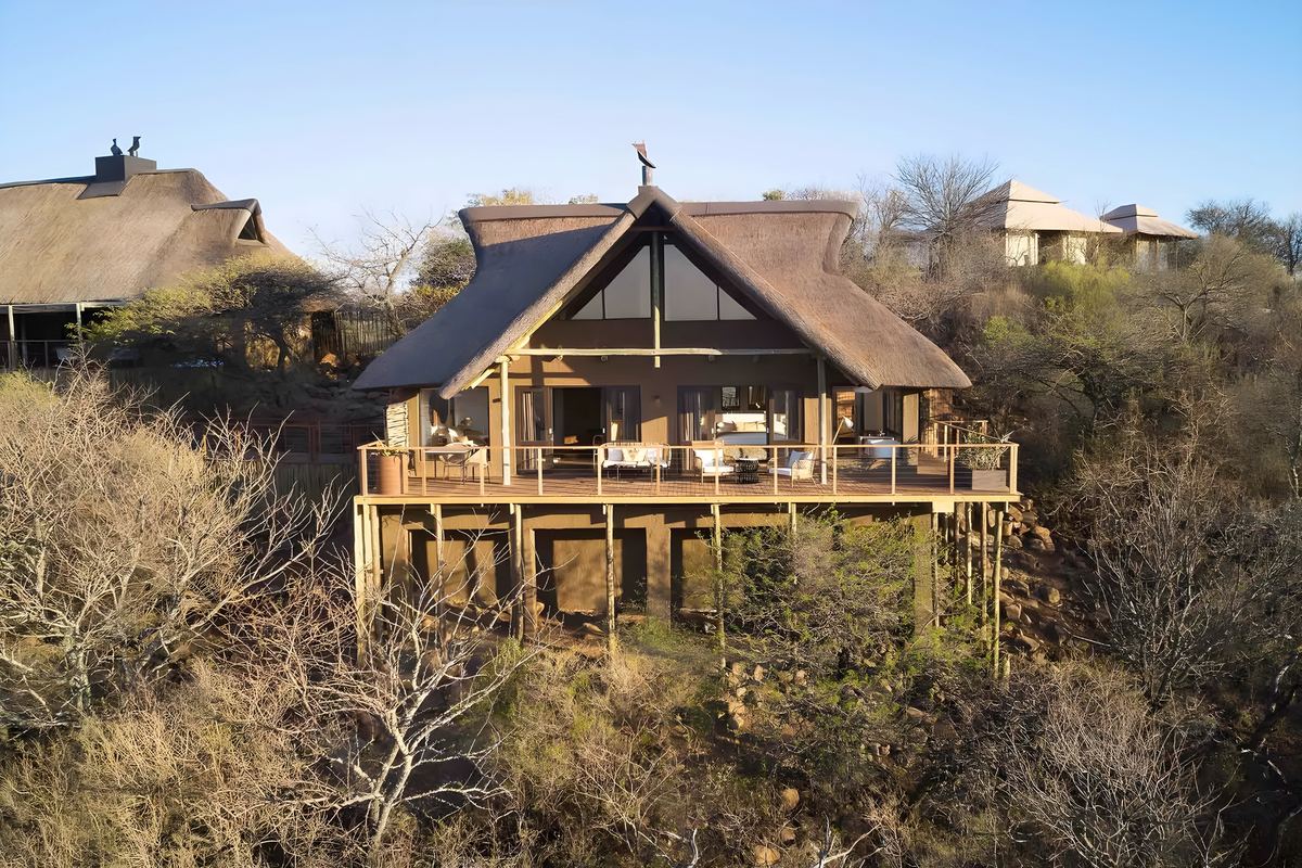 A thatched suite standing on stilts above the valley