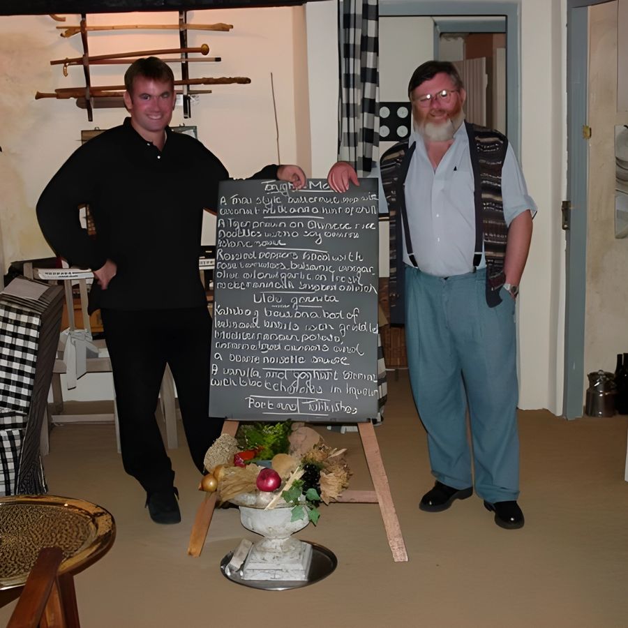 John Sparks and Richard Poynton beside the chalkboard menu in Cleopatra's dining room in 2000