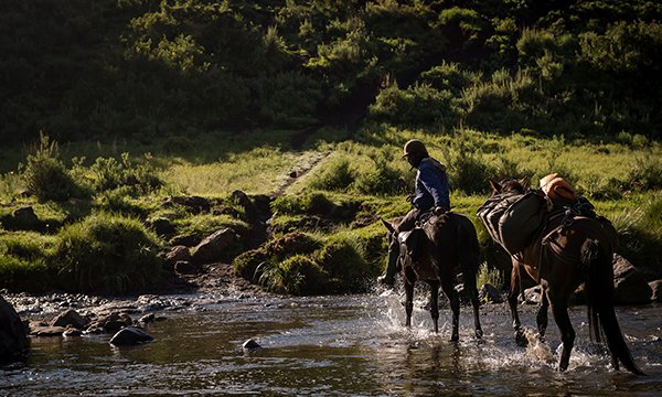 Crossing the river on horseback