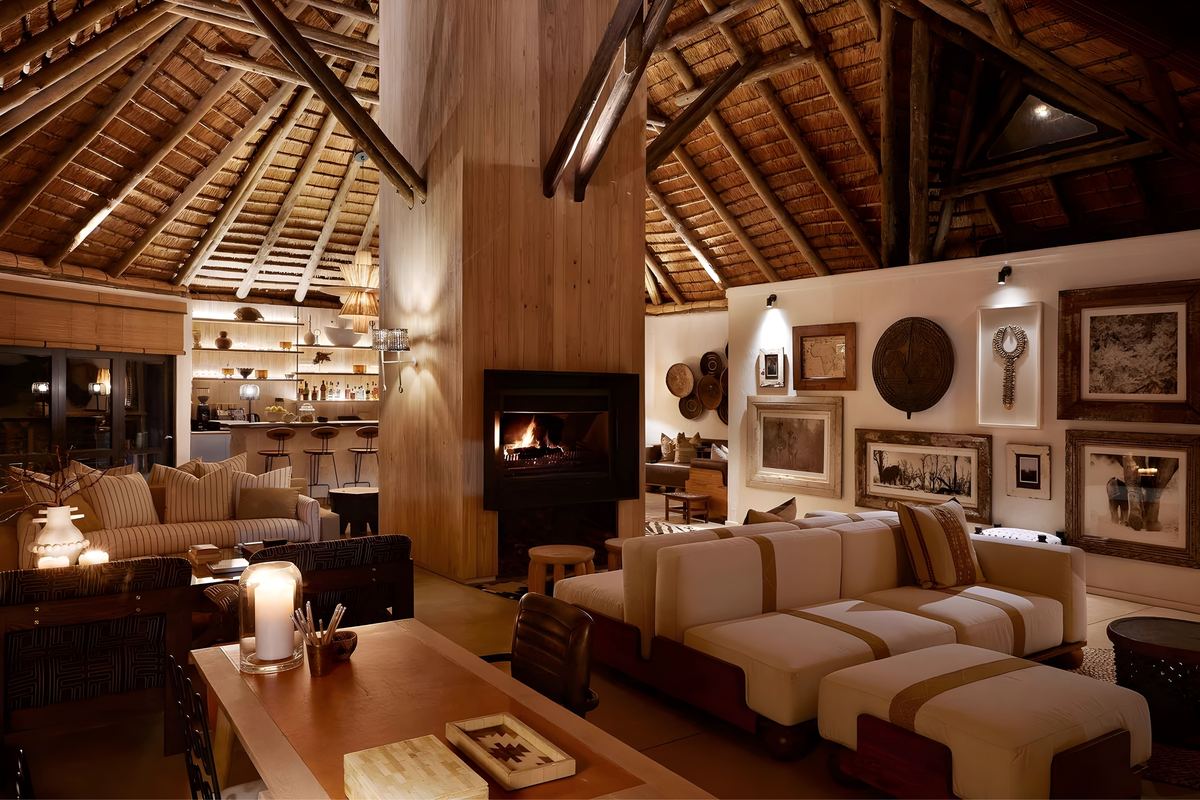 The lounge at night, lit by the fire and candles