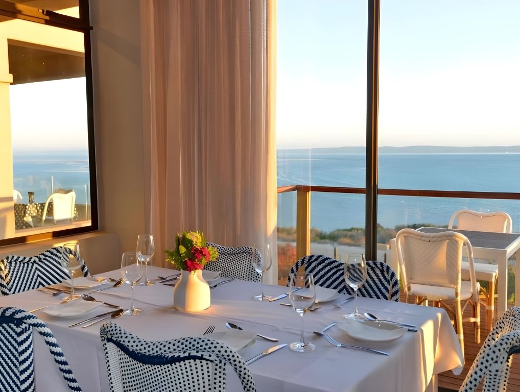 A table laid in the restaurant, with the lagoon beyond the glass