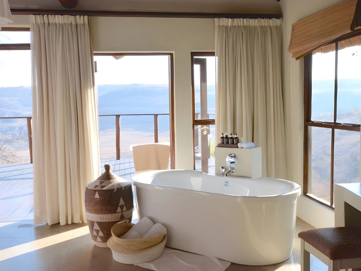 A freestanding bath facing the view